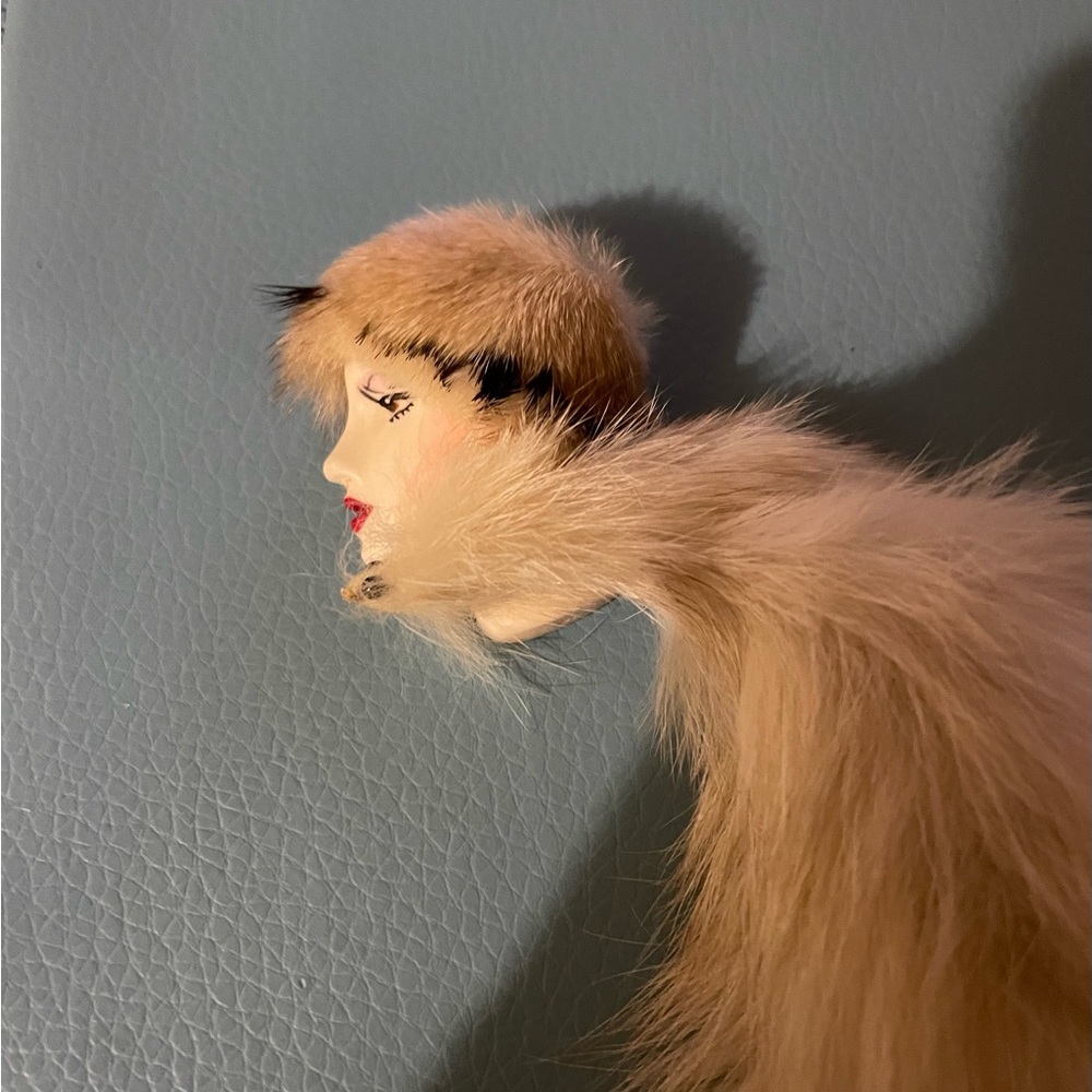 Vintage lady fur brooch with porcelain painted face.
